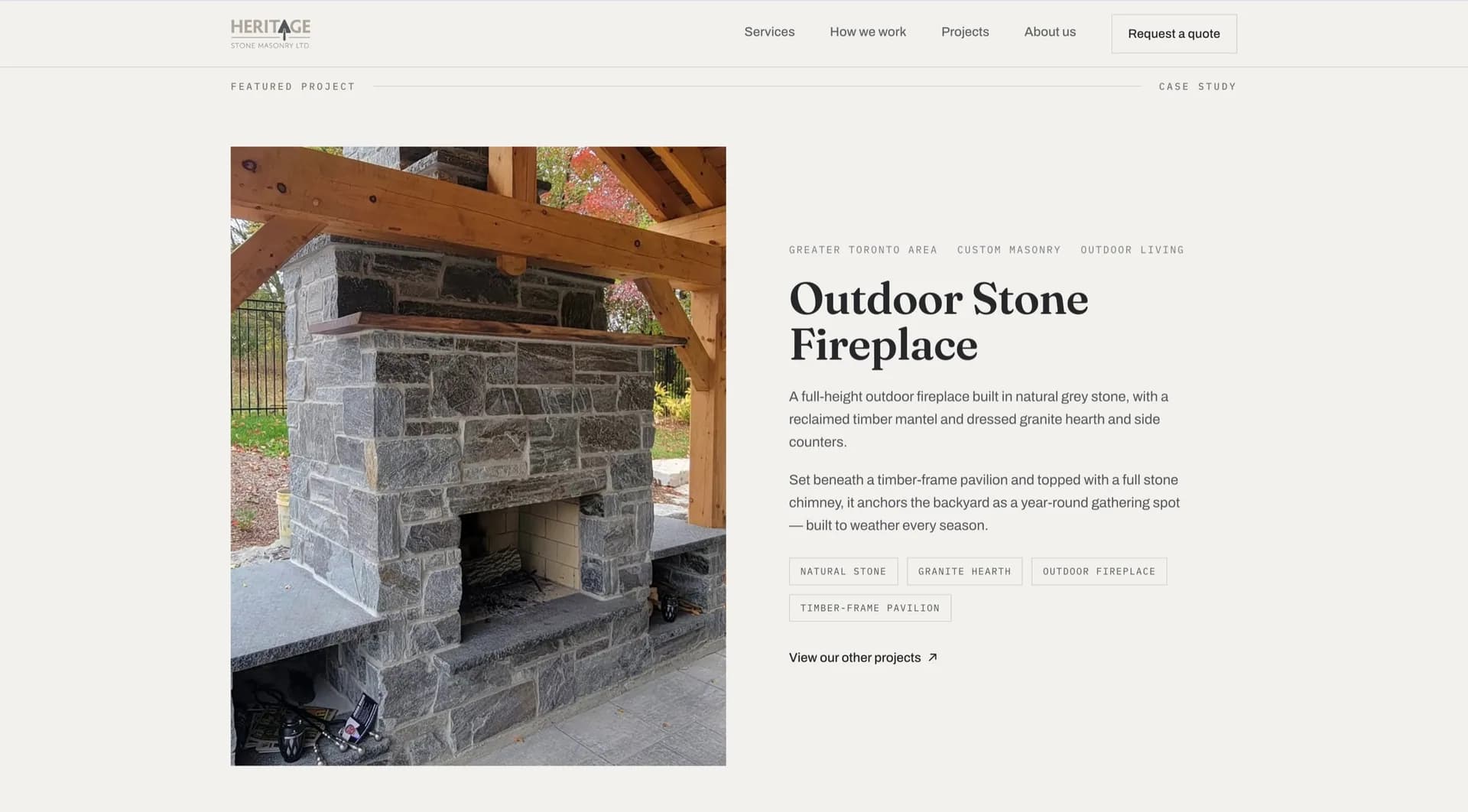 A Heritage Stone Masonry featured project: a full-height outdoor stone fireplace beneath a timber-frame pavilion, described alongside its materials.