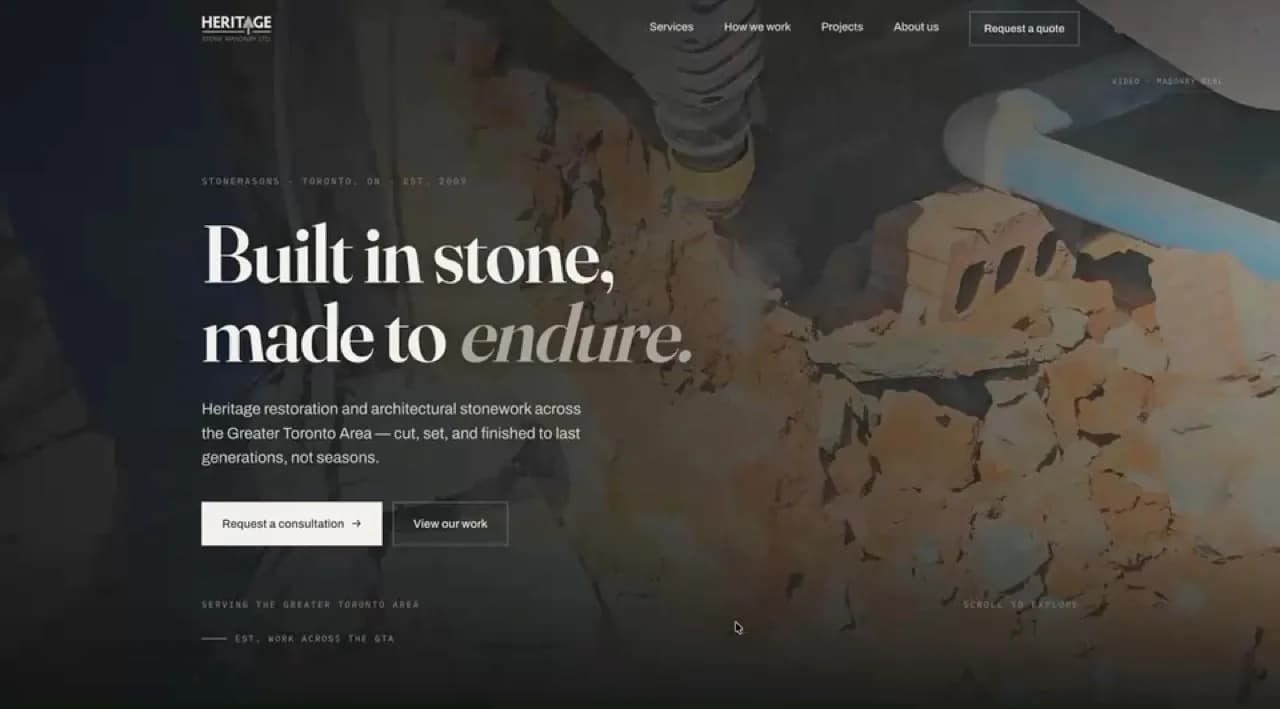Heritage Stone Masonry homepage hero: the headline “Built in stone, made to endure.” in a serif typeface over a darkened video of stone being cut.